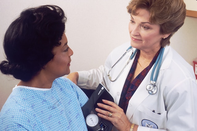 A doctor examines a patient to represent endowment spend as a symptom.