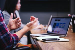 The picture shows a person talking in a meeting to represent the communicating of data.