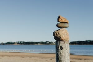 The picture is of a cairn (balanced rocks) to represent reding costs, financial balance and financial sustainability.